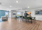 Thumbnail 6 of 22 - a dining room and living room with a table and chairs