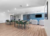 Thumbnail 5 of 22 - a dining room with tables and chairs and a tv on the wall