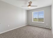 Thumbnail 17 of 22 - an empty living room with a ceiling fan and a window