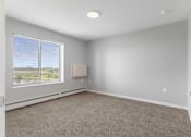 Thumbnail 18 of 22 - an empty living room with a large window and carpet