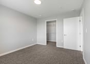 Thumbnail 19 of 22 - an empty bedroom with a closet and a door to a bathroom
