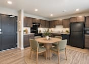 Thumbnail 19 of 71 - A modern kitchen with a dining table and chairs.