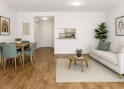 Thumbnail 2 of 14 - A living room with a dining table and chairs.