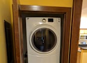 Thumbnail 3 of 29 - A white front loading washing machine is in a wooden door.