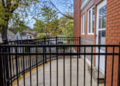 Thumbnail 14 of 15 - A black metal fence surrounds a brick building.