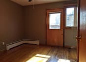 Thumbnail 11 of 15 - A room with a brown wall and a ceiling fan.