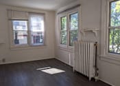 Thumbnail 21 of 29 - A room with a white radiator and a window with blinds.