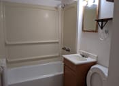 Thumbnail 22 of 29 - A white bathroom with a toilet, sink, and bathtub.