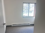 Thumbnail 9 of 14 - A room with a window and a radiator on the floor.