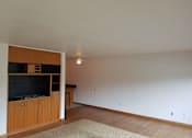 Thumbnail 4 of 15 - A room with a ceiling fan and a rug on the floor.