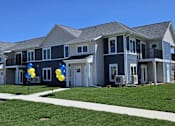 Thumbnail 2 of 34 - an apartment building with balloons in front of it