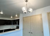 Thumbnail 8 of 34 - a kitchen with a cabinet and a chandelier