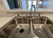 Thumbnail 12 of 34 - a stainless steel sink with two faucets in a kitchen