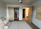 Thumbnail 15 of 34 - a living room with a couch and a hallway with a closet