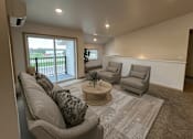 Thumbnail 4 of 34 - a living room with couches and chairs and a rug