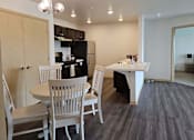 Thumbnail 6 of 34 - a dining room and kitchen with a table and chairs