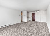 Thumbnail 14 of 19 - A room with a carpeted floor and a ceiling fan.