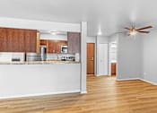 Thumbnail 7 of 19 - A kitchen with wooden cabinets and a white counter.