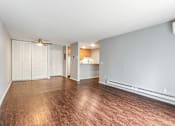 Thumbnail 9 of 20 - A room with wood flooring and a ceiling fan.