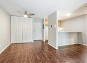 Thumbnail 18 of 20 - A room with a ceiling fan and wood flooring.