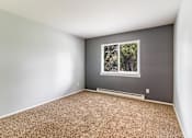 Thumbnail 13 of 20 - A room with a window and carpeted floor.