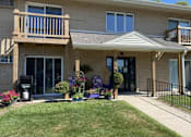 Thumbnail 1 of 2 - A two-story house with a balcony and a front porch.