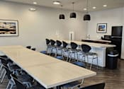 Thumbnail 6 of 15 - a conference room with a long table and chairs and a kitchen
