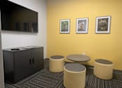 Thumbnail 5 of 15 - a room with four stools and a table and a tv