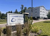 Thumbnail 1 of 15 - A Cambrian Community sign is in front of a building.