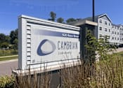 Thumbnail 2 of 15 - A large white sign with a blue logo and the word
