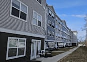 Thumbnail 14 of 15 - a row of houses with a sidewalk in front of them