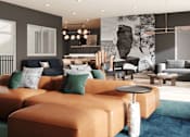 Thumbnail 24 of 54 - A modern living room with a large sectional sofa and a coffee table.