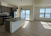 Thumbnail 9 of 54 - A kitchen with a marble countertop and a refrigerator.