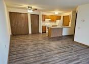 Thumbnail 5 of 11 - A kitchen area with wooden cabinets and a refrigerator.