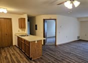 Thumbnail 11 of 11 - A kitchen with wooden cabinets and a countertop is shown.