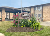 Thumbnail 1 of 20 - a sign in front of a building