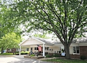 Thumbnail 1 of 19 - a house with an american flag in front of it