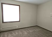 Thumbnail 7 of 19 - an empty room with a window and a radiator