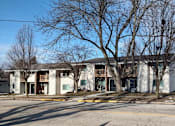 Thumbnail 1 of 6 - a white building with trees in front of it