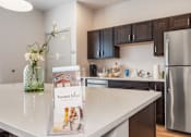 Thumbnail 3 of 38 - A kitchen with a white countertop and a sign that says "Forest Edge".