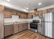 Thumbnail 5 of 38 - A kitchen with wooden cabinets and stainless steel appliances.