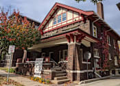 Thumbnail 5 of 29 - A house with a red roof and a sign that says