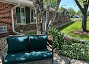 Thumbnail 4 of 4 - A green couch is in the foreground of a sunny backyard.
