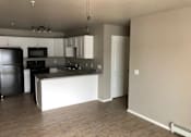 Thumbnail 6 of 29 - A kitchen with wooden cabinets and stainless steel appliances.