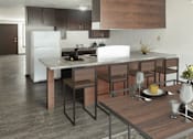 Thumbnail 2 of 5 - A modern kitchen with a dining table set for two.