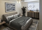 Thumbnail 3 of 5 - A bedroom with a large bed and a painting on the wall.