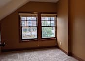 Thumbnail 12 of 29 - A room with a window and a carpet on the floor.