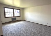 Thumbnail 6 of 14 - A room with a grey carpet and a window.