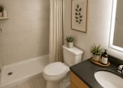 Thumbnail 26 of 37 - A white toilet sits in a bathroom next to a sink and a bathtub.