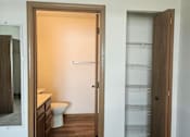 Thumbnail 11 of 16 - A bathroom with a toilet and a towel rack.